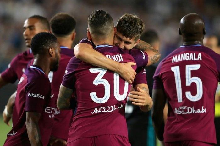 Manchester City's John Stones congratulates teammate Nicolas Otamendi after scoring a goal during their International Champions Cup match against Real Madrid, at Los Angeles Memorial Coliseum, on July 26, 2017