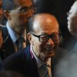 Hong Kong tycoon Li Ka-shing (C) said he was "cautiously optimistic" about his company's future, as an upturn in major economies was weighed by geopolitical risks