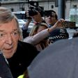 Cardinal George Pell arrives under heavy police protection for his first court hearing over historical sexual abuse allegations