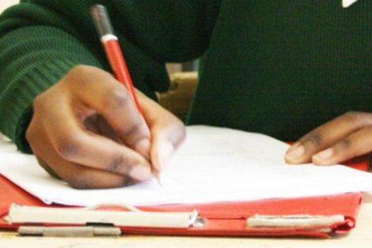 A candidate writing for her exam