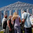 People pause in front of the "Parthenon of Books" by Argentinian artist Marta Minujin, at the Documenta 14 art exhibition in Kassel