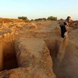 Unemployed former fisherman Chamseddine Marzouz digs a grave at a makeshift cemetery for migrants on July 12, 2017 in the Tunisian town of Zarzis