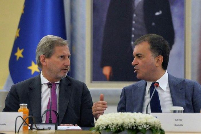 Turkish EU affairs minister, Omer Celik, seen with EU enlargement commissioner Johannes Hahn, blasted EU lawmakers' vote to freeze accession talks as "a politically motivated decision" which was "sabotaging relations"