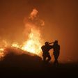 Firemen seek to control a blaze at Pietracorbara on August 11, 2017, on the French island of Corsica