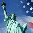 Statue of Liberty and United States flag waving in wind