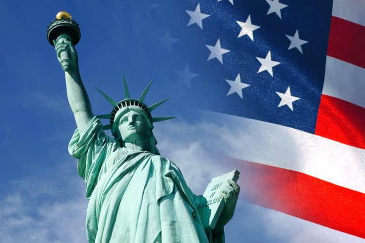 Statue of Liberty and United States flag waving in wind
