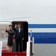 China's President Xi Jinping and his wife Peng Liyuan wave as they depart from Hong Kong's international airport, on July 1, 2017