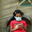 A Yemeni child suspected of being infected with cholera sits outside a makeshift hospital in Sanaa