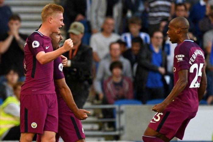 Manchester City's striker Sergio Aguero (2nd L) celebrates with midfielders Kevin De Bruyne (L) and Fernandinho (R) at the American Express Community Stadium in Brighton, southern England on August 12, 2017