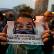 An opposition activist holds a sign reading "The fight of the few is for the future of the many" during a protest against Venezuelan President Nicolas Maduro in Caracas on July 13, 2017