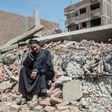 Egyptian Shoukran Rashwan, 75, sits on the rubble of her demolished house on Cairo's Warraq island on July 20, 2017
