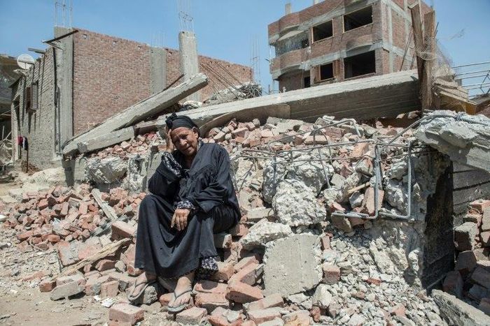 Egyptian Shoukran Rashwan, 75, sits on the rubble of her demolished house on Cairo's Warraq island on July 20, 2017
