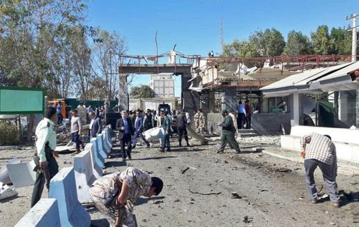 Iranian police survey the aftermath of a suicide car bombing which killed at least two people and wounded many more outside police headquarters in the southeastern port city of Chabahar