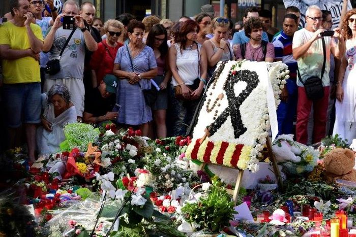 Flowers and candles are placed on Las Ramblas boulevard in Barcelona in tribute to the victims of the twin attacks in Spain