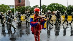 Venezuelan opposition demonstrator Wuilly Arteaga, shown here playing his violin during a May protest against President Nicolas Maduro in Caracas, has been banned from rallies after nearly three weeks in prison Arteaga, 23, was freed overnight on Augus...