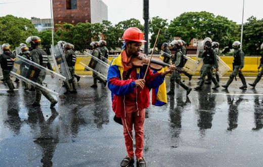 Venezuelan opposition demonstrator Wuilly Arteaga, shown here playing his violin during a May protest against President Nicolas Maduro in Caracas, has been banned from rallies after nearly three weeks in prison Arteaga, 23, was freed overnight on Augus...