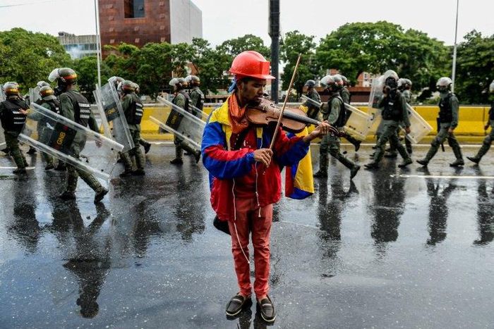 Venezuelan opposition demonstrator Wuilly Arteaga, shown here playing his violin during a May protest against President Nicolas Maduro in Caracas, has been banned from rallies after nearly three weeks in prison Arteaga, 23, was freed overnight on Augus...