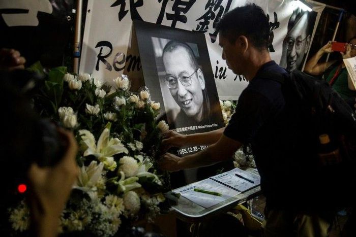 Democracy activists and members of the public gathered outside China's liaison office in Hong Kong Thursday night to mourn the death in custody of China's Nobel laureate Liu Xiaobo and vent their anger at Beijing.