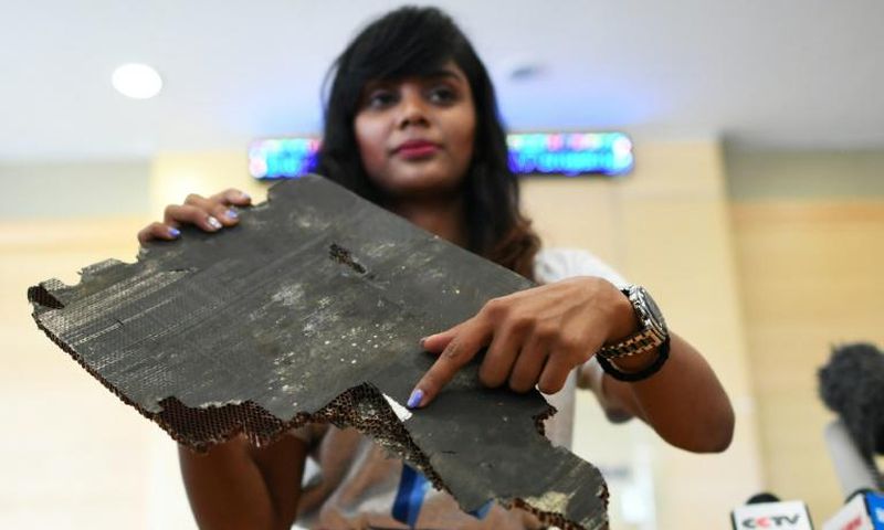 Grace Subathirai Nathan, whose mother Anne Daisy was on board Flight MH370, shows a piece of debris believed to be part of the ill-fated plane