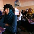 Iraqi girls attend a class at a school in western Mosul on July 27, 2017