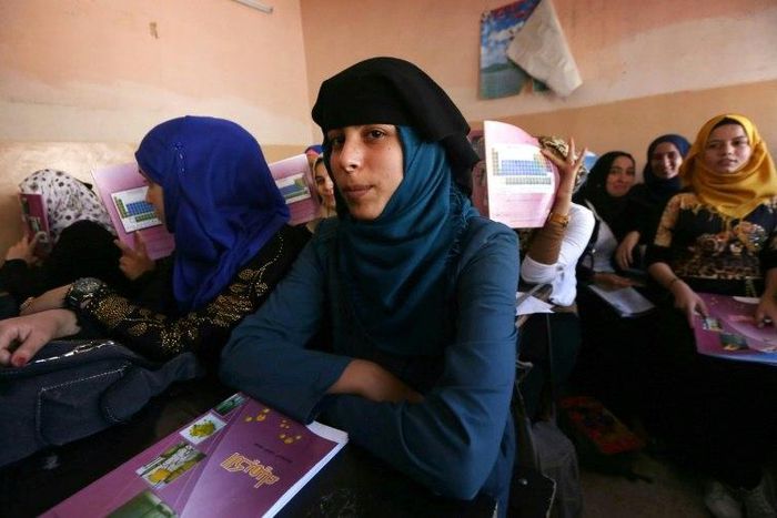Iraqi girls attend a class at a school in western Mosul on July 27, 2017
