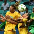 Emily Van Egmond (L) and Kyah Simon of Australia fight for the ball with Zimbabwe's Lynett Mutokuto during their Rio 2016 Olympic Games women's football match, in Salvador