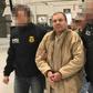 Joaquin Guzman Loera aka "El Chapo" Guzman (C) is escorted in Ciudad Juarez by the Mexican police as he is extradited to the United States
