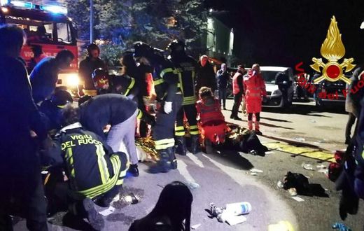 This handout picture taken and released by the Italian fire and rescue service shows emergency personnel treating victims after the stampede in Corinaldo
