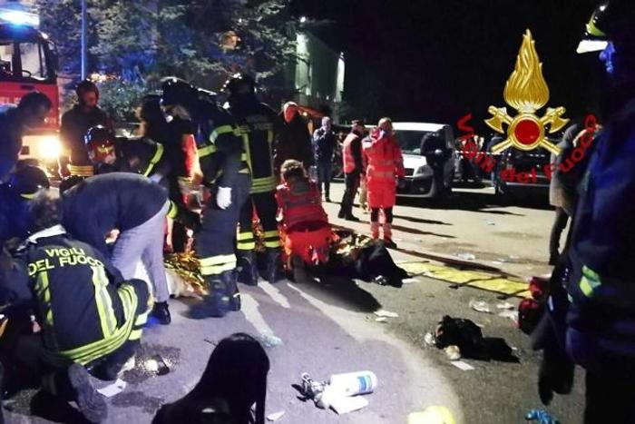 This handout picture taken and released by the Italian fire and rescue service shows emergency personnel treating victims after the stampede in Corinaldo