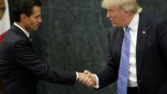 Mexican President Enrique Pena Nieto (L) and US presidential candidate Donald Trump shake hands after a meeting in Mexico City on August 31, 2016
