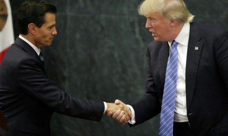 Mexican President Enrique Pena Nieto (L) and US presidential candidate Donald Trump shake hands after a meeting in Mexico City on August 31, 2016