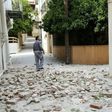 A man walks through a damaged street in the village of Plomari on the Greek island of Lesbos on June 12, 2017