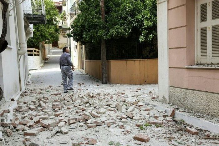 A man walks through a damaged street in the village of Plomari on the Greek island of Lesbos on June 12, 2017