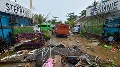 Debris from damaged buildings is strewn across a road in Carita after the area was hit by a tsunami following an eruption of the Anak Krakatoa volcano