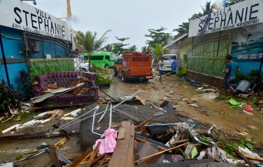Debris from damaged buildings is strewn across a road in Carita after the area was hit by a tsunami following an eruption of the Anak Krakatoa volcano