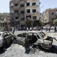 Charred vehicles are seen on the site of a suicide bomb attack in the Syrian capital's eastern Tahrir Square district, on July 2, 2017