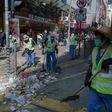 Workers clear debris on a street following the Mongkok riots of February 2016