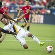 Manchester United's Marcus Rashford kicks the ball past Hugo Arellano of Los Angeles Galaxy during a friendly match in Carson, California