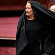Australian One Nation party leader, Senator Pauline Hanson pulls off a burqa in the Senate chamber at Parliament House in Canberra, Australia, August 17, 2017.