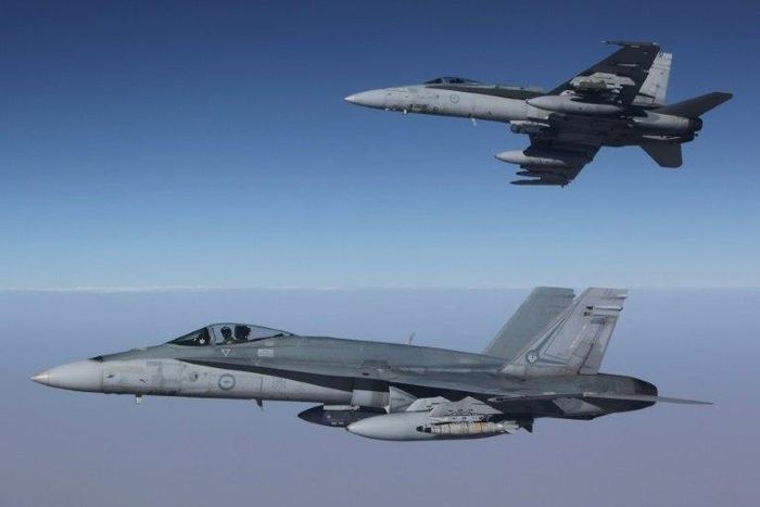 Royal Australian Air Force F/A-18A Hornets fly in formation after refuelling from a KC-30A on a mission over Syria. Australia has temporarily halted air missions following the shooting down of a Syrian jet by US forces