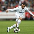 Swansea City's midfielder Leon Britton runs with the ball during the English Premier League football match against Manchester City September 24, 2016