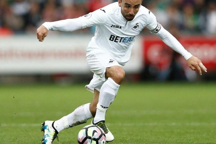 Swansea City's midfielder Leon Britton runs with the ball during the English Premier League football match against Manchester City September 24, 2016