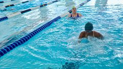 Durbin looks on as Washington swims breast stroke.
