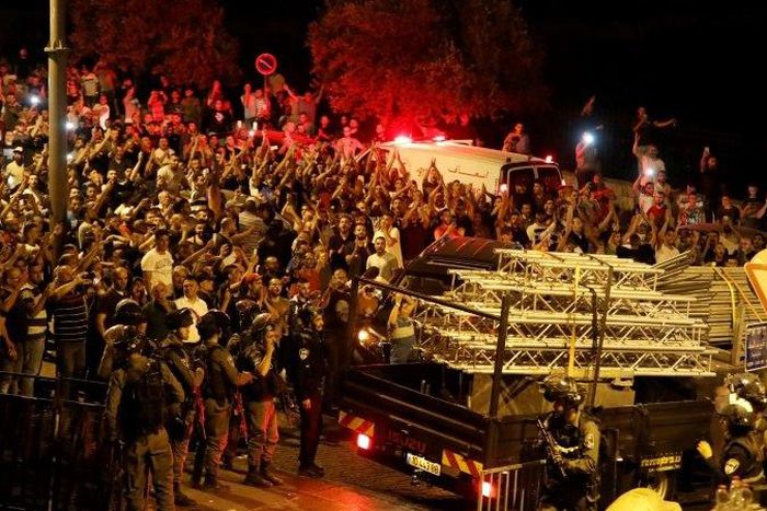 Palestinians celebrate outside the Al-Aqsa mosque compound on July 27, 2017, after more new Israeli security barriers were removed from the entrance