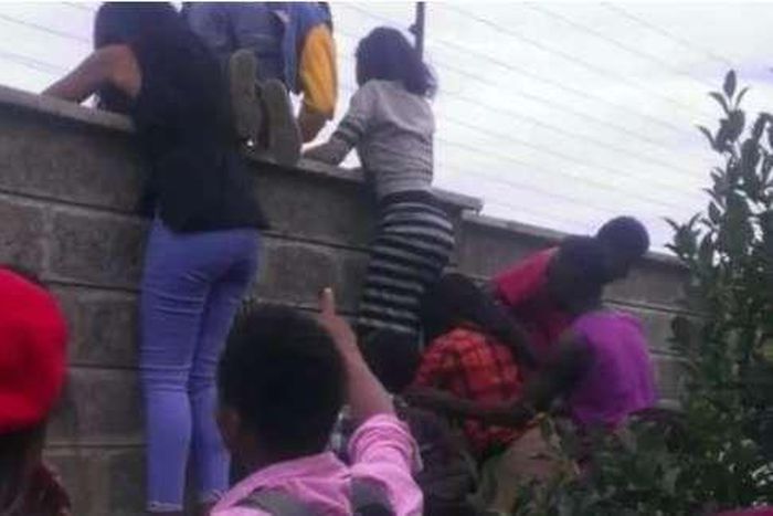 File image of teenagers attempting to jump over a fence during a previous raid