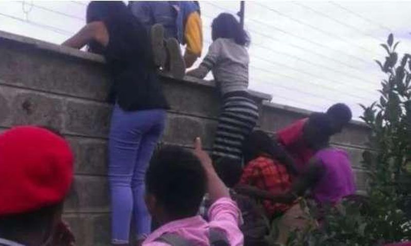 File image of teenagers attempting to jump over a fence during a previous raid