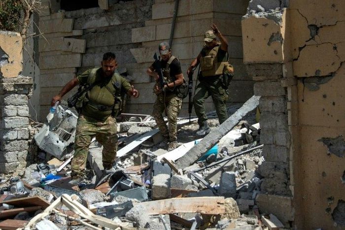 Iraq's elite Rapid Response Division patrol a medical complex in Al-Shifaa neighbourhood, on the west bank of Mosul, on July 1, 2017