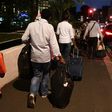 Residents walk with luggage and possessions as they evacuate from the Taplow Tower residential block on the Chalcots Estate in north London on June 23, 2017 because of fire safety concerns