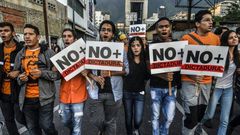 Opposition demonstrators march towards the Organisation of American States (OAS) headquarters in Caracas on June 21, 2017, after the 47th OAS General Assembly taking place in Cancun, Mexico, ruled out issuing a resolution on Venezuela