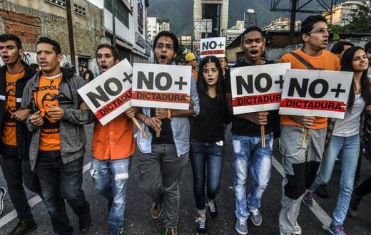 Opposition demonstrators march towards the Organisation of American States (OAS) headquarters in Caracas on June 21, 2017, after the 47th OAS General Assembly taking place in Cancun, Mexico, ruled out issuing a resolution on Venezuela